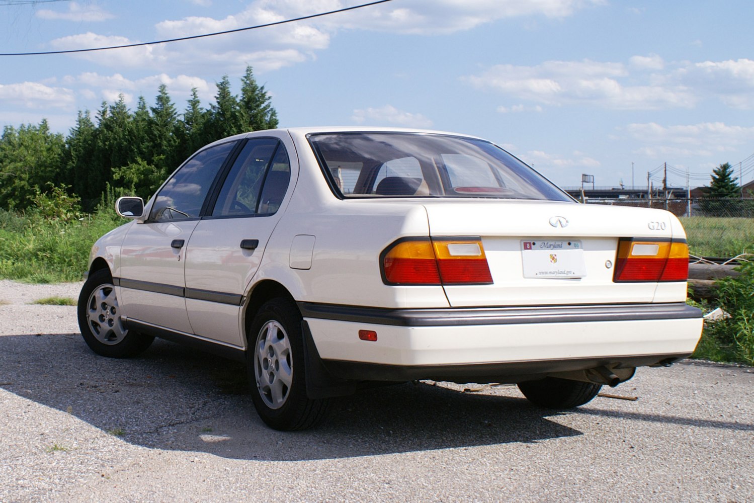 Rear view of a 1991 sedan with distinctive taillights and 4 doors