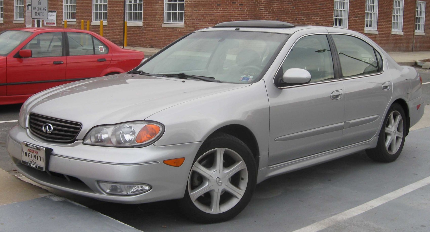 Silver sedan front side view with alloy wheels and sunroof