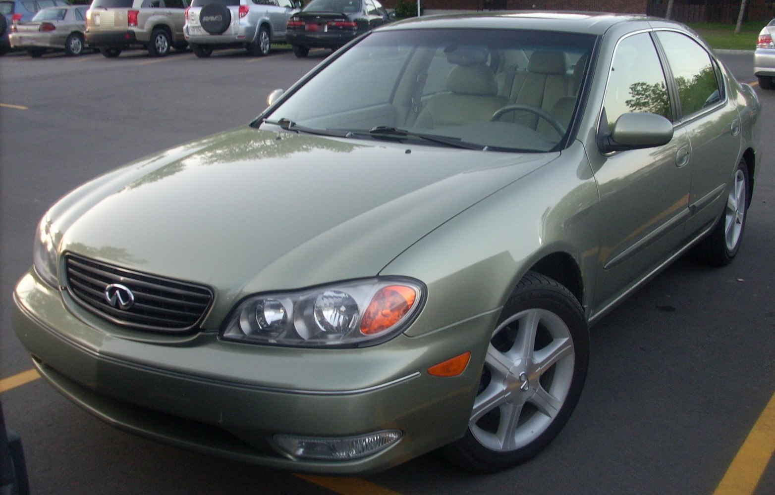 Front view with headlights, grille, alloy wheels, and side mirror