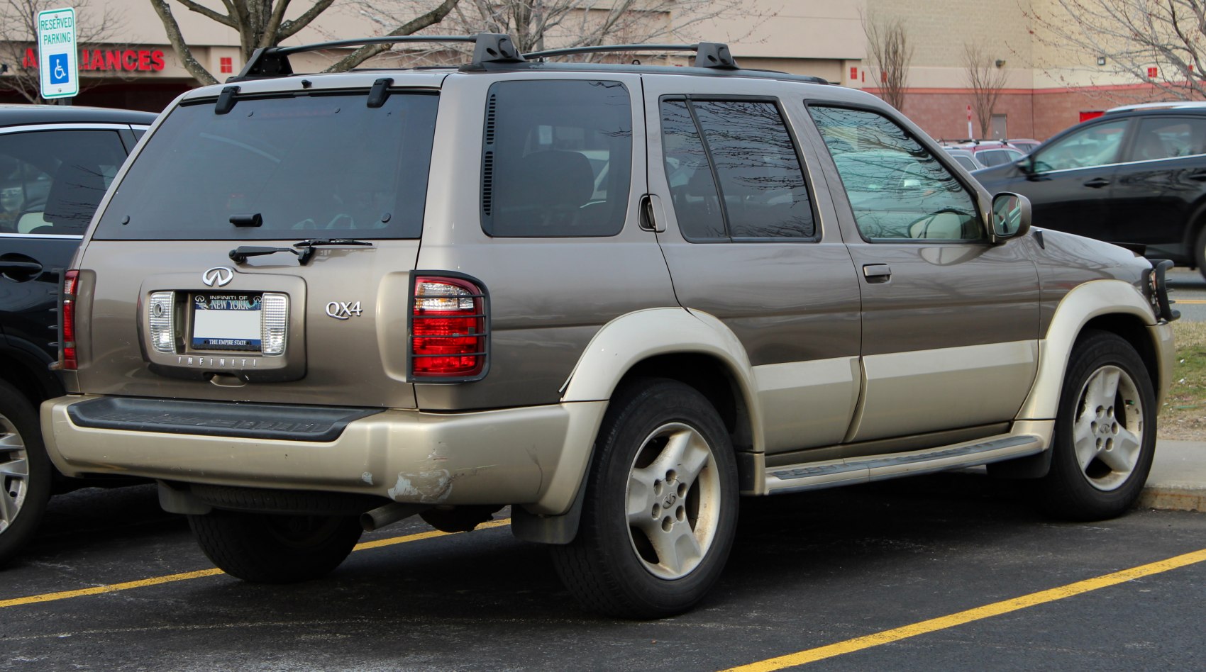 Rear view of classic 1990s SUV with tinted windows and roof rack