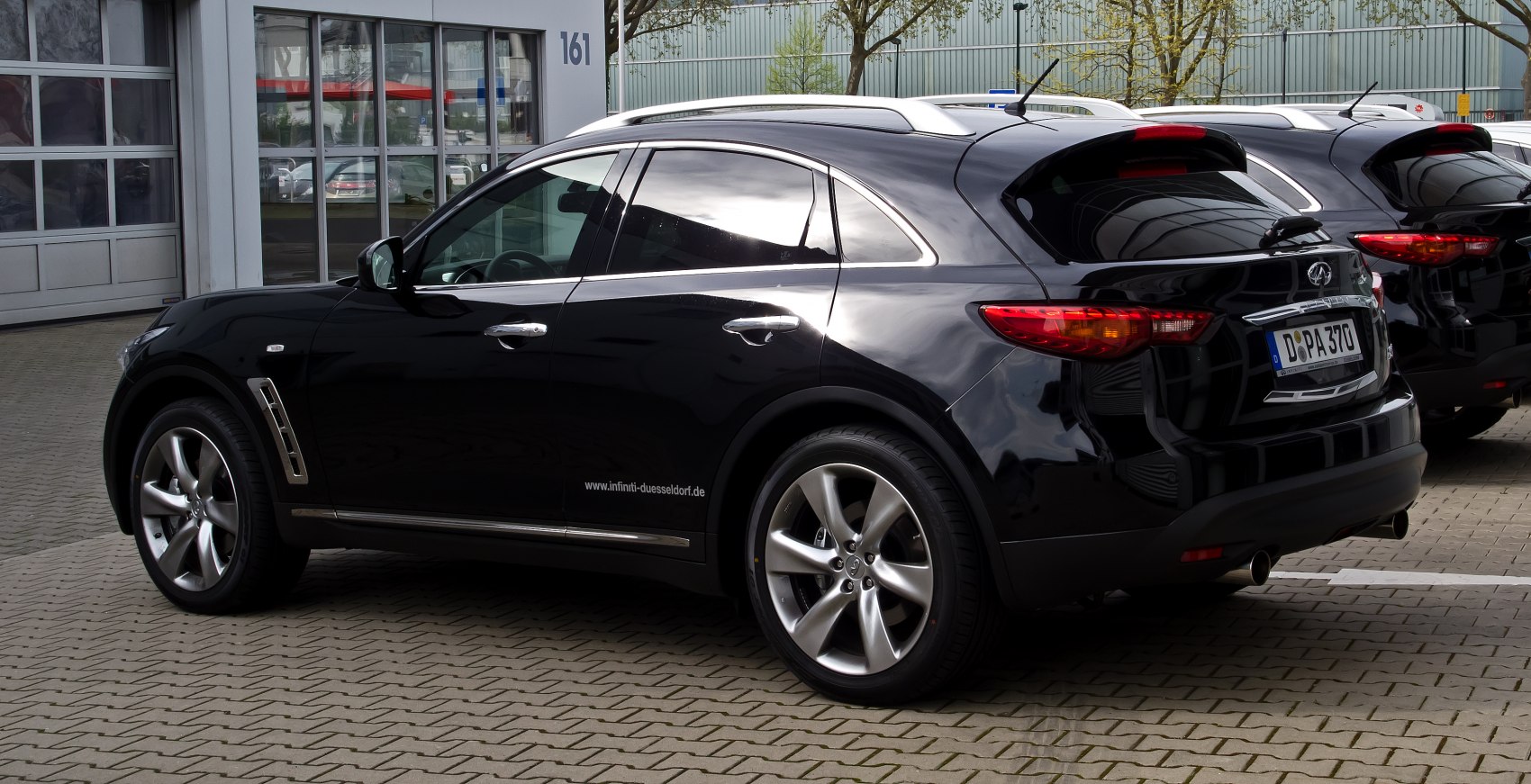 Side profile of black SUV with alloy wheels and chrome accents
