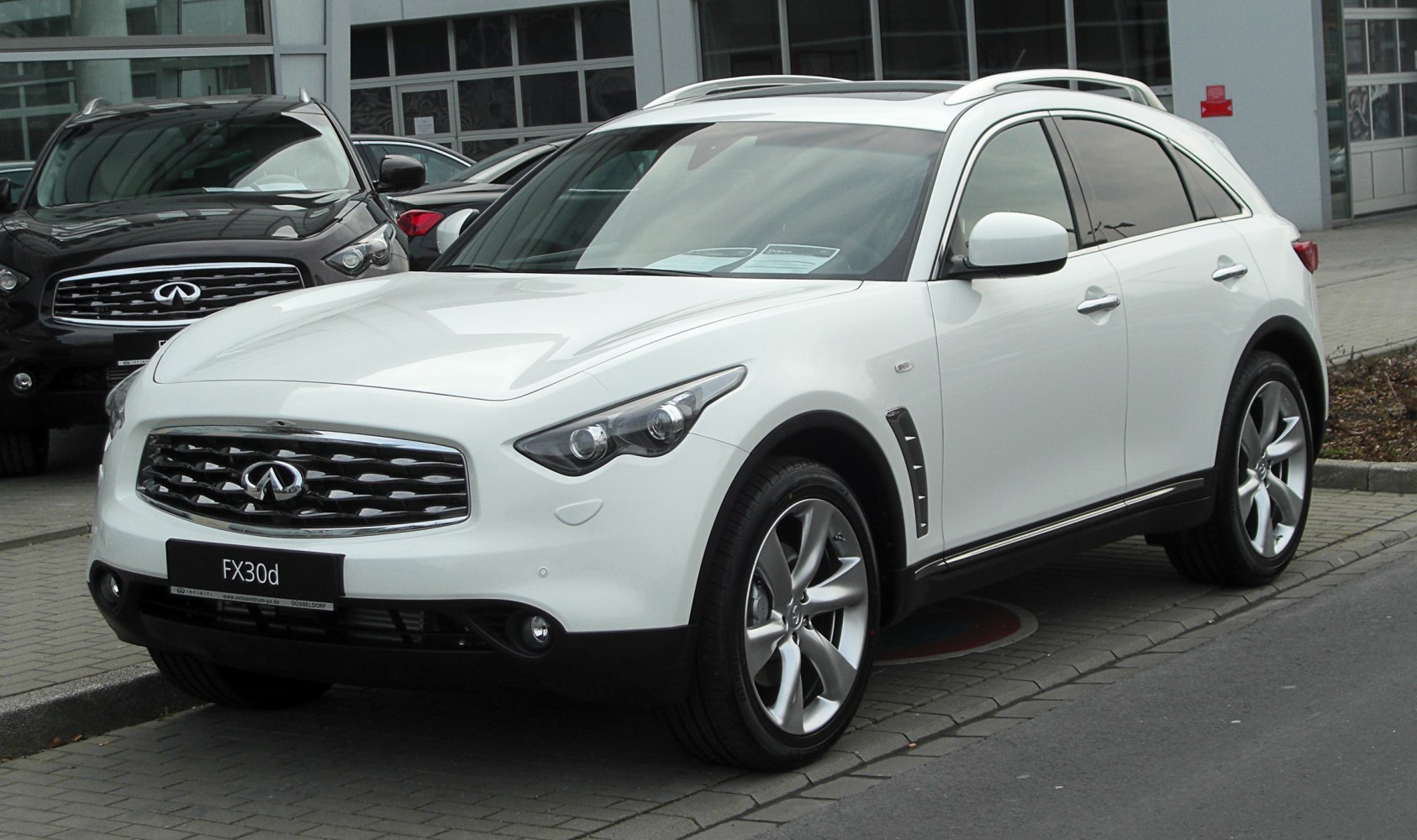 White SUV with LED headlights, distinctive grille, and alloy wheels.