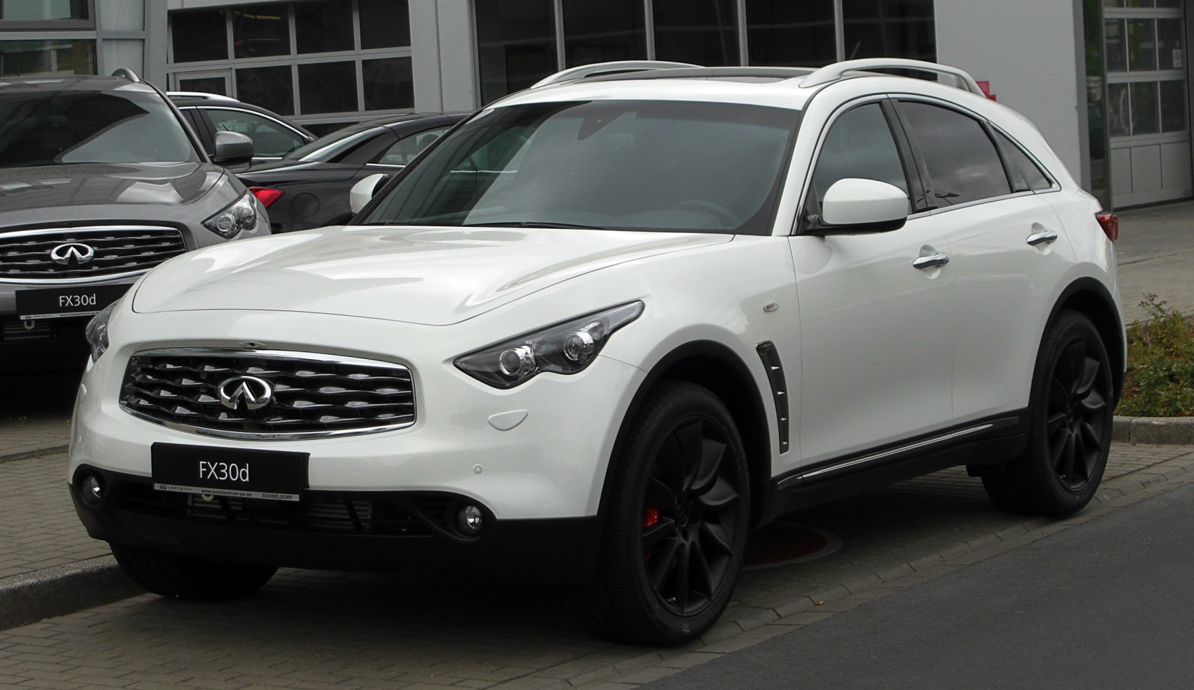 Front and side view of white SUV with black alloy wheels