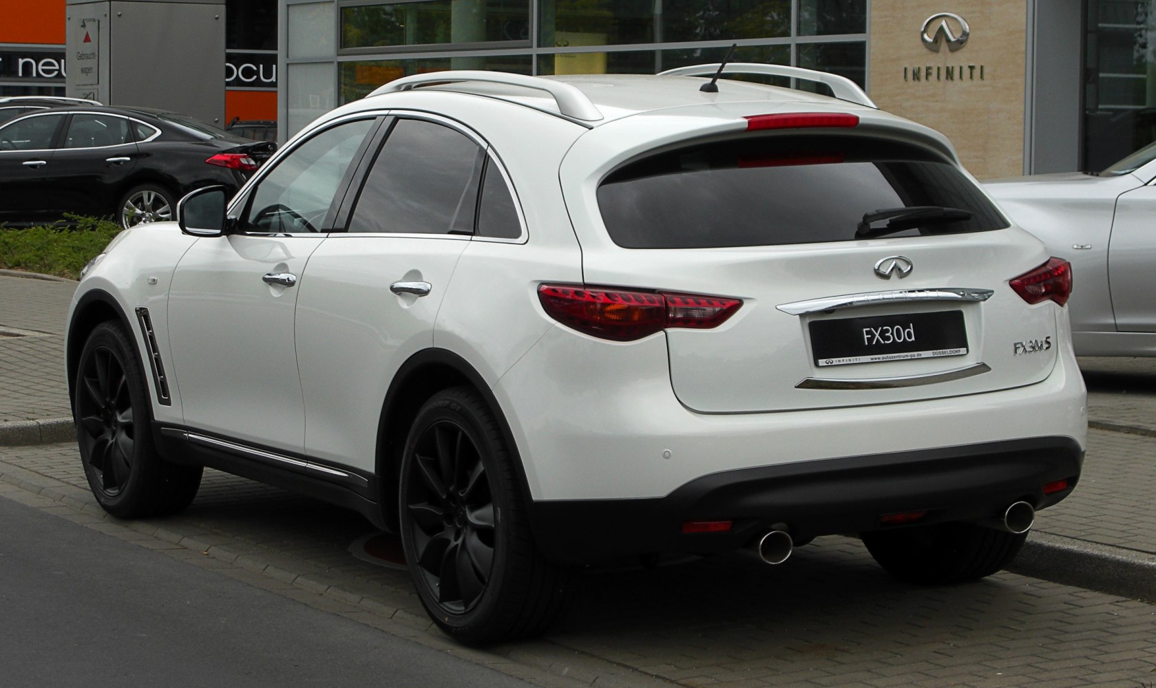 Rear view showing dual exhaust and roof rails