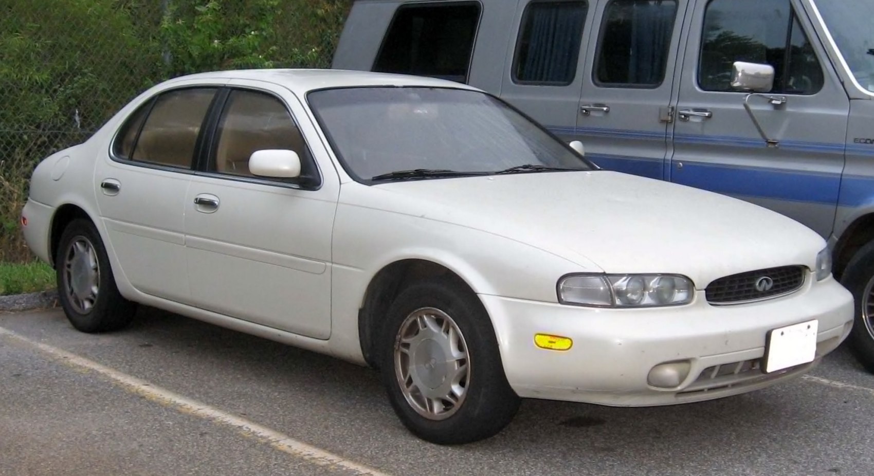 1990s luxury sedan with round twin headlights and smooth body lines
