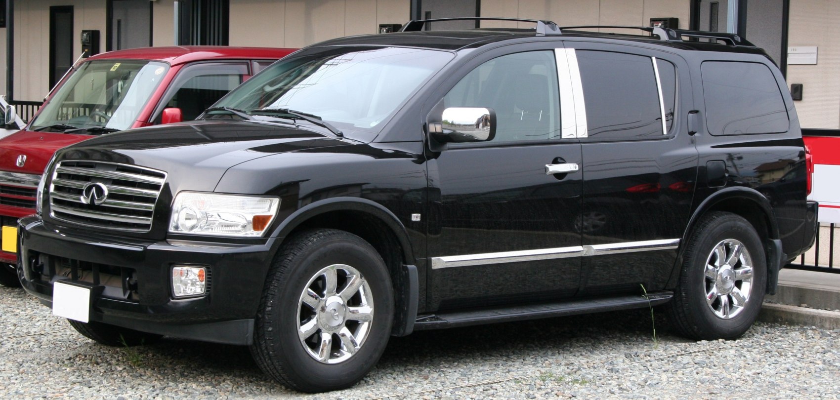 Black full-size SUV with chrome accents and roof rails
