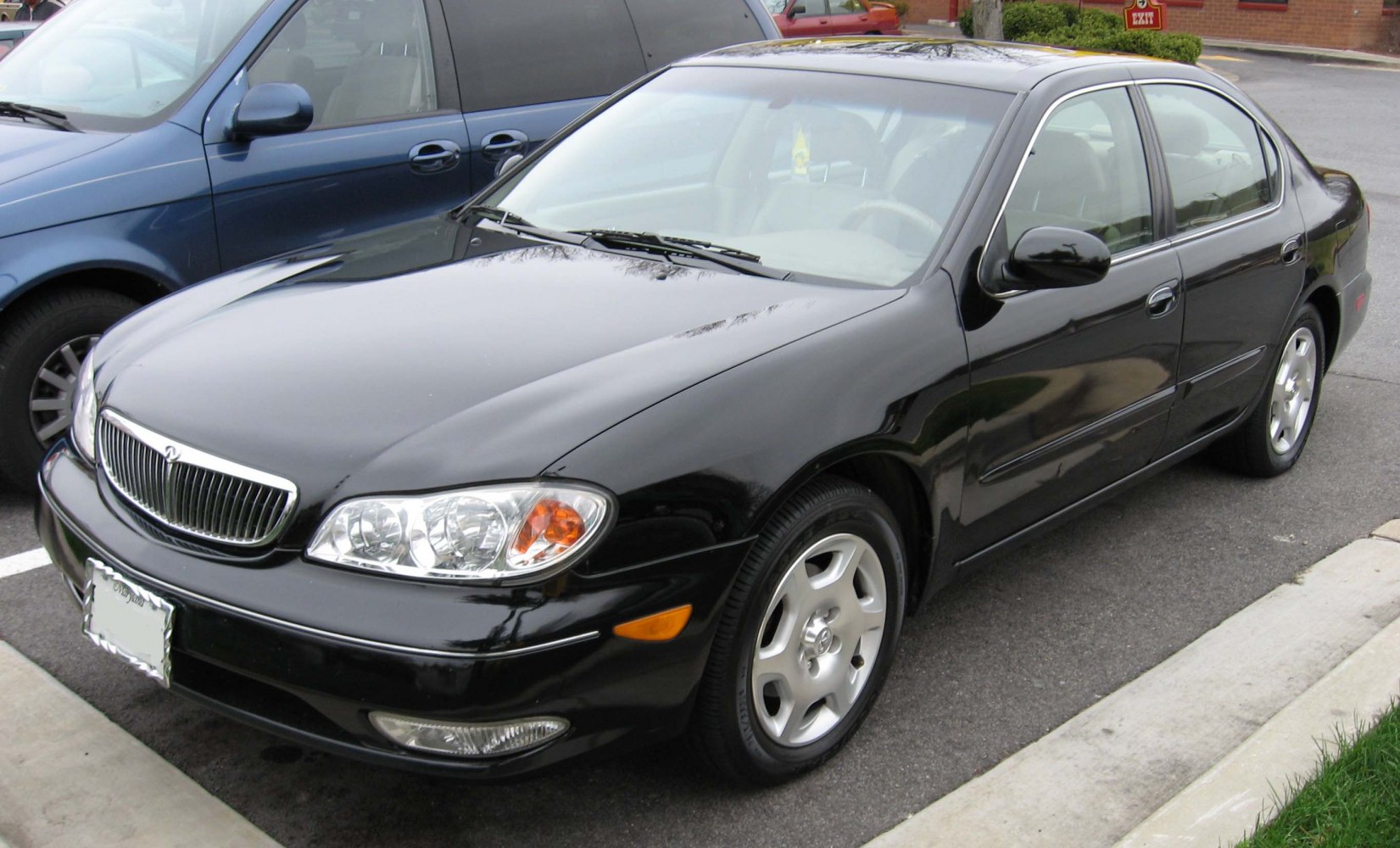 Black sedan front three-quarter view with chrome grille and clear headlights