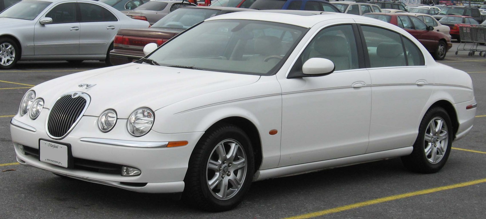 White sedan with quad round headlights and chrome grille