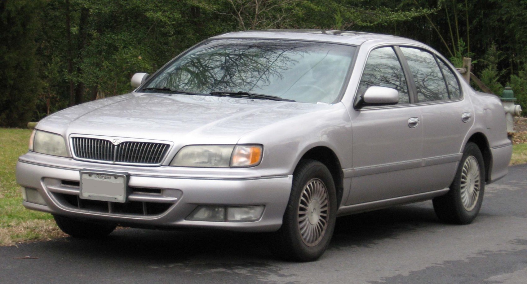 Classic mid-90s sedan front-side view with grille and headlights
