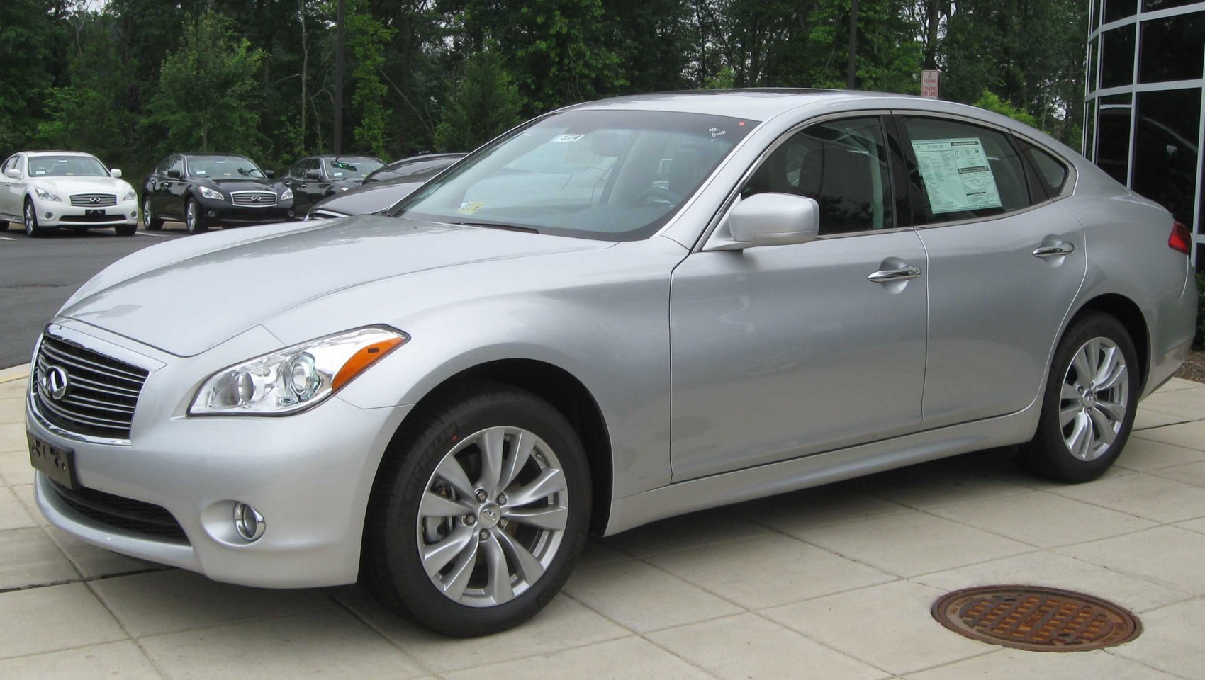 Silver sedan with headlights and alloy wheels front-side view