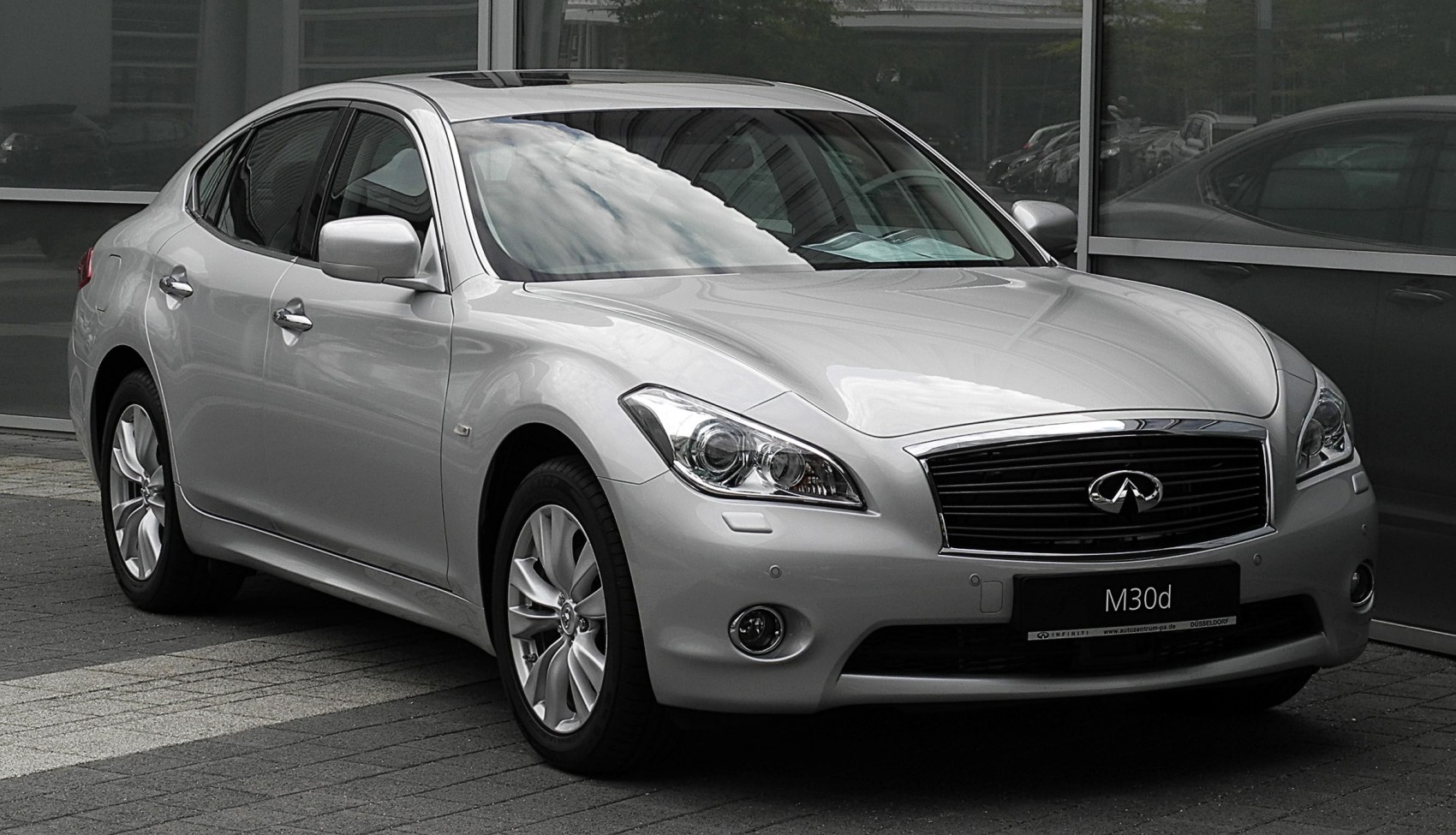 Silver luxury sedan front and side view with alloy wheels