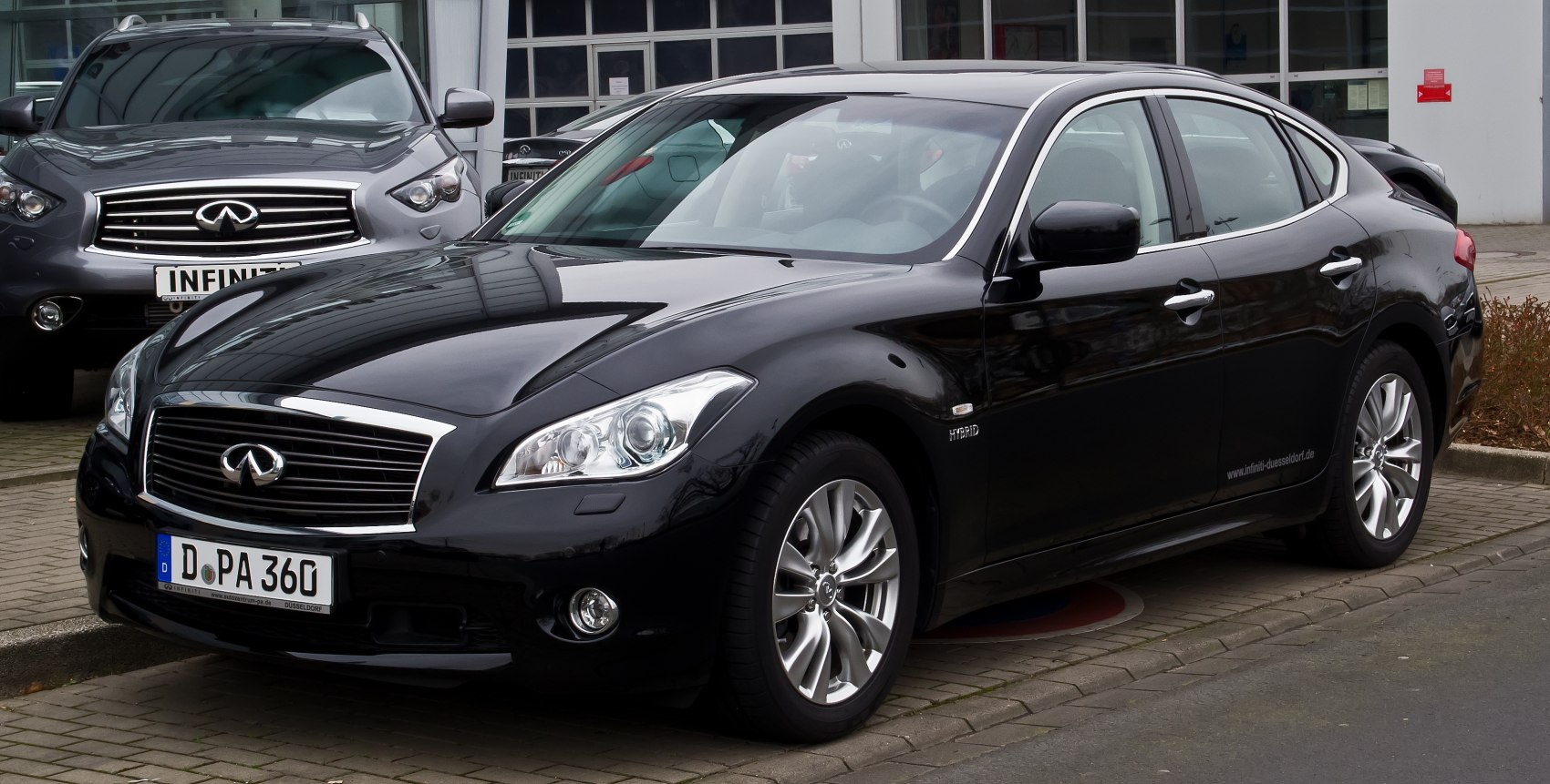 Luxury black sedan with hybrid badge and alloy wheels