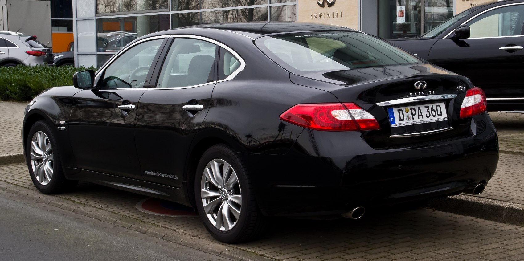 Black sedan with dual exhaust and LED rear lights