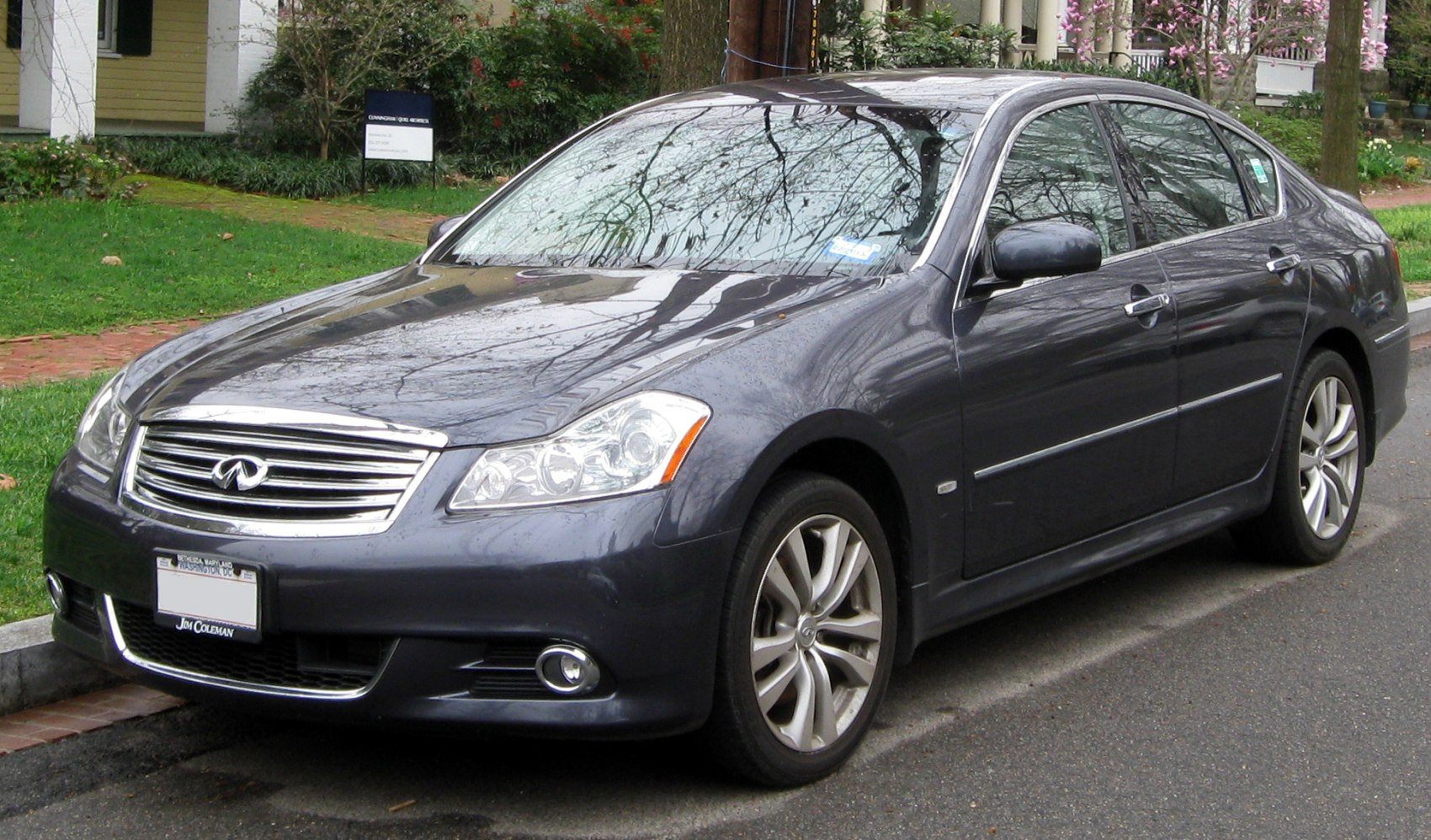 Front side view of a sedan with chrome grille and alloy wheels