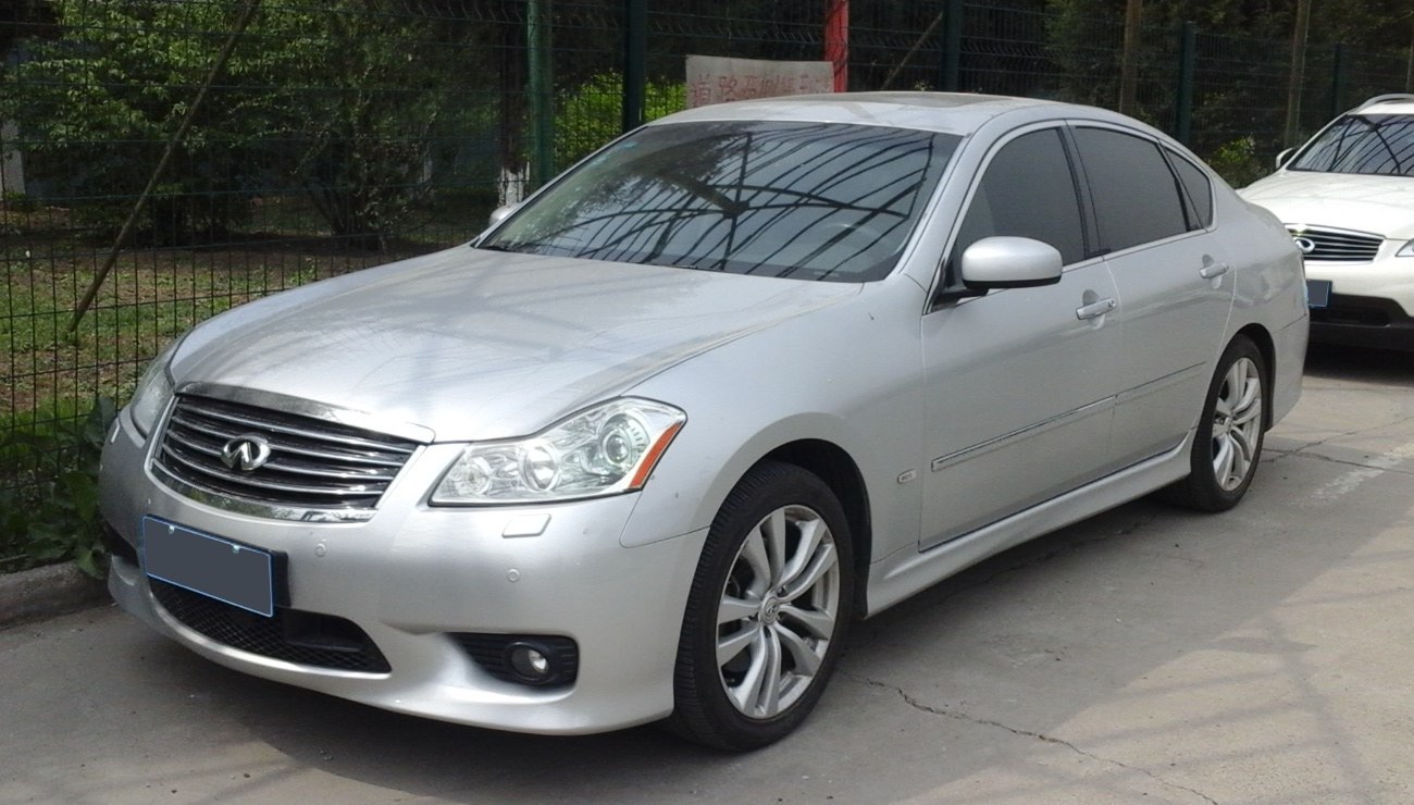 Silver sedan with prominent front grille and alloy wheels