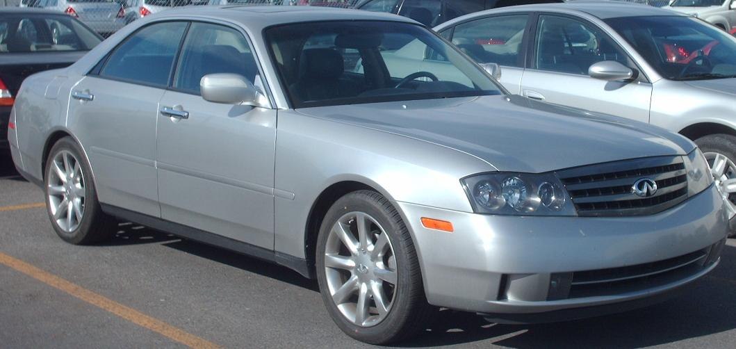 Silver mid-size sedan with multi-spoke alloy wheels and distinct headlights