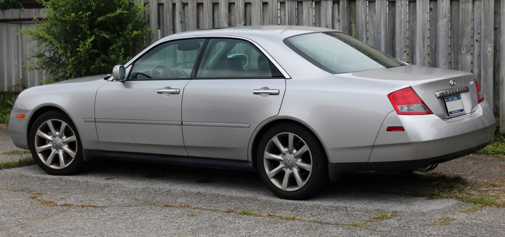 Silver luxury sedan showing side and rear profiles with alloy wheels