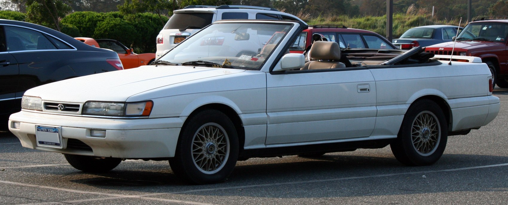 White luxury convertible with alloy wheels and rear antenna
