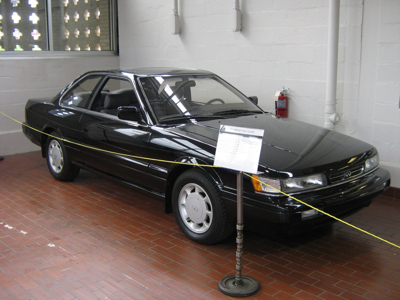 Side-front view of a sleek two-door vintage coupe.