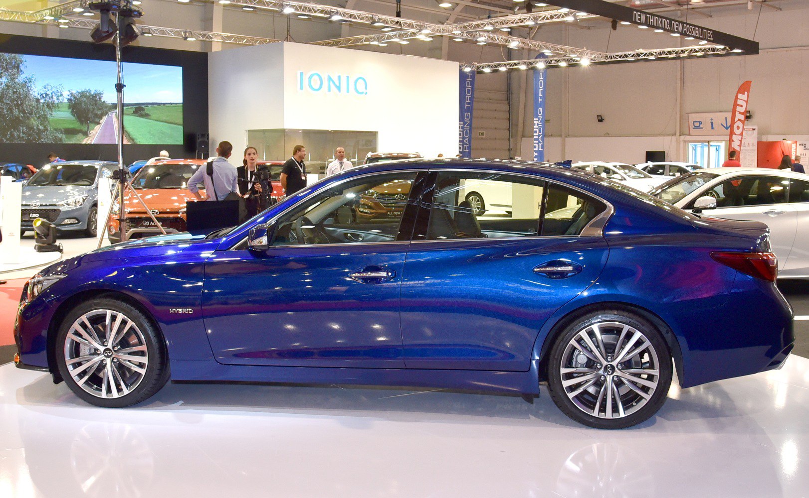 Side profile of blue hybrid sedan with modern wheels