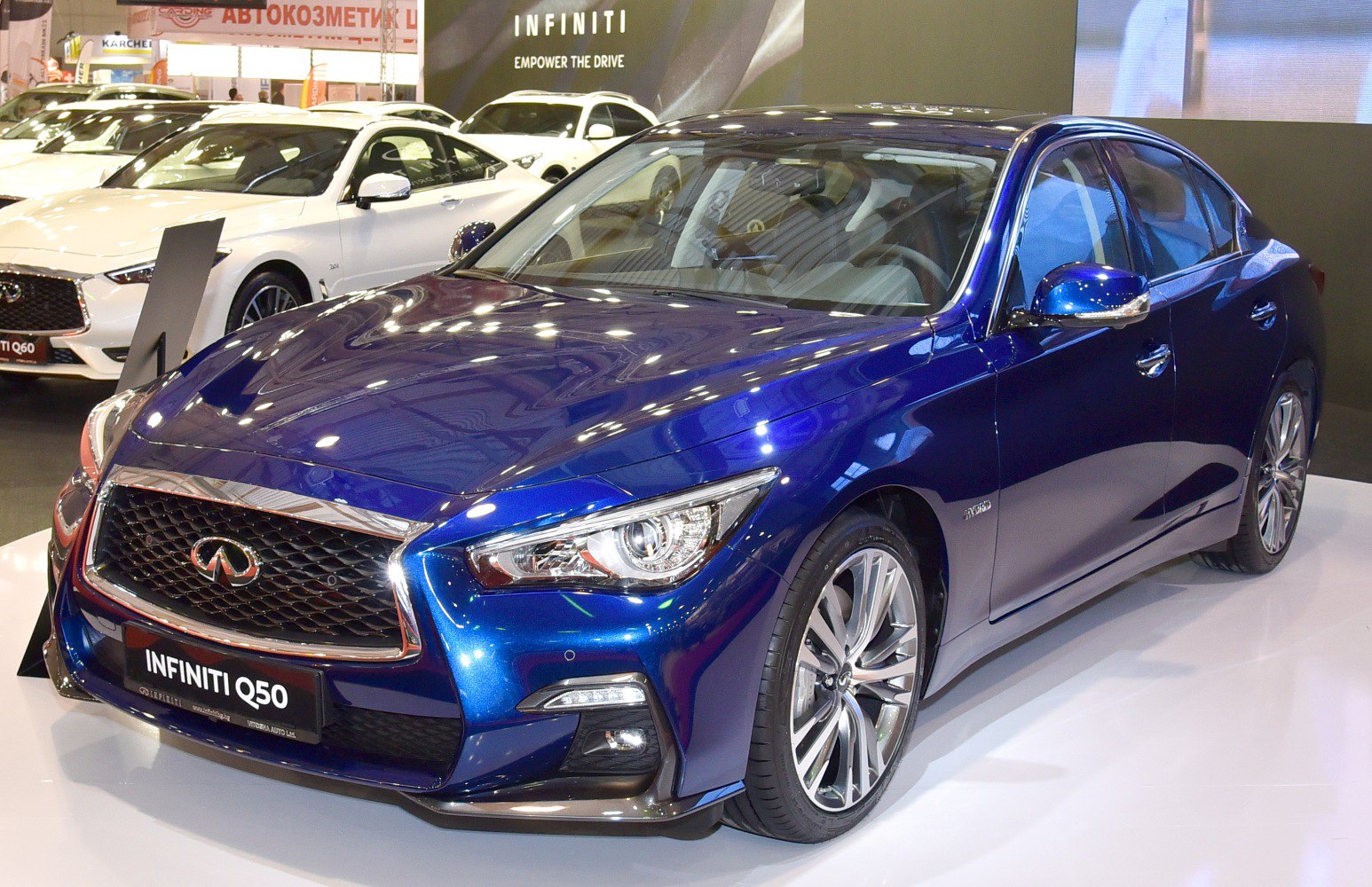 Blue luxury sedan with sharp LED headlights and alloy wheels