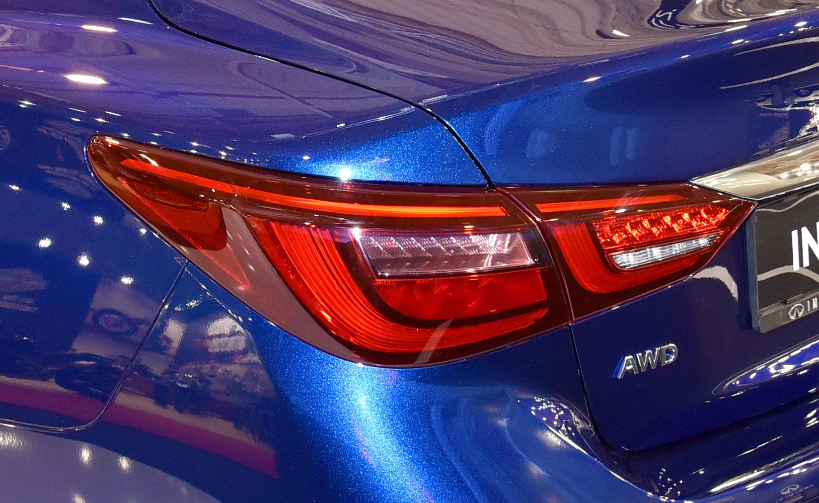 Rear LED taillight and AWD badge on metallic blue vehicle body