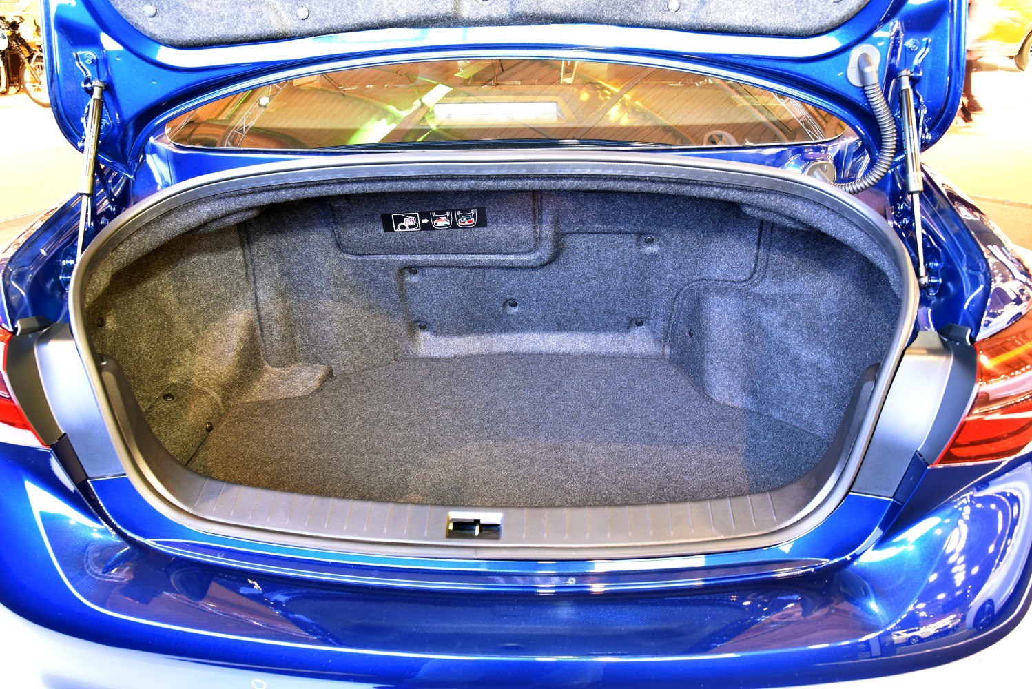 Spacious and carpeted trunk interior with clean design and folding seat release