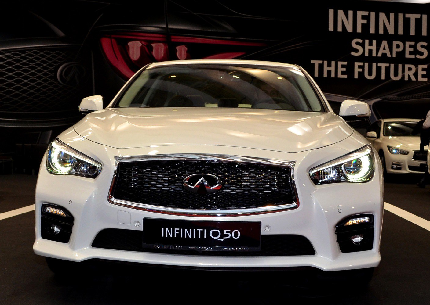 Front view with LED headlights and black mesh grille with chrome trim