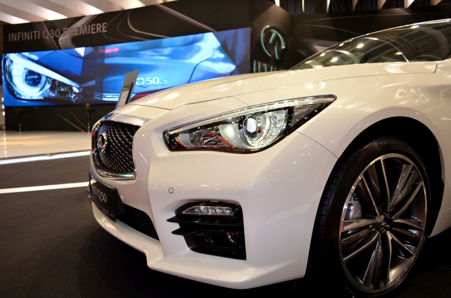 Close-up of front headlight and alloy wheel