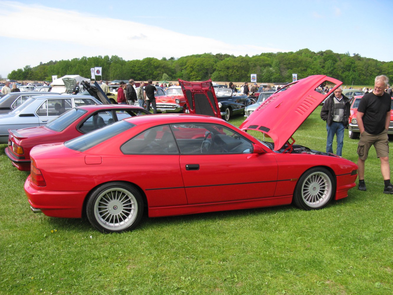 Red coupe with raised hood and alloy wheels