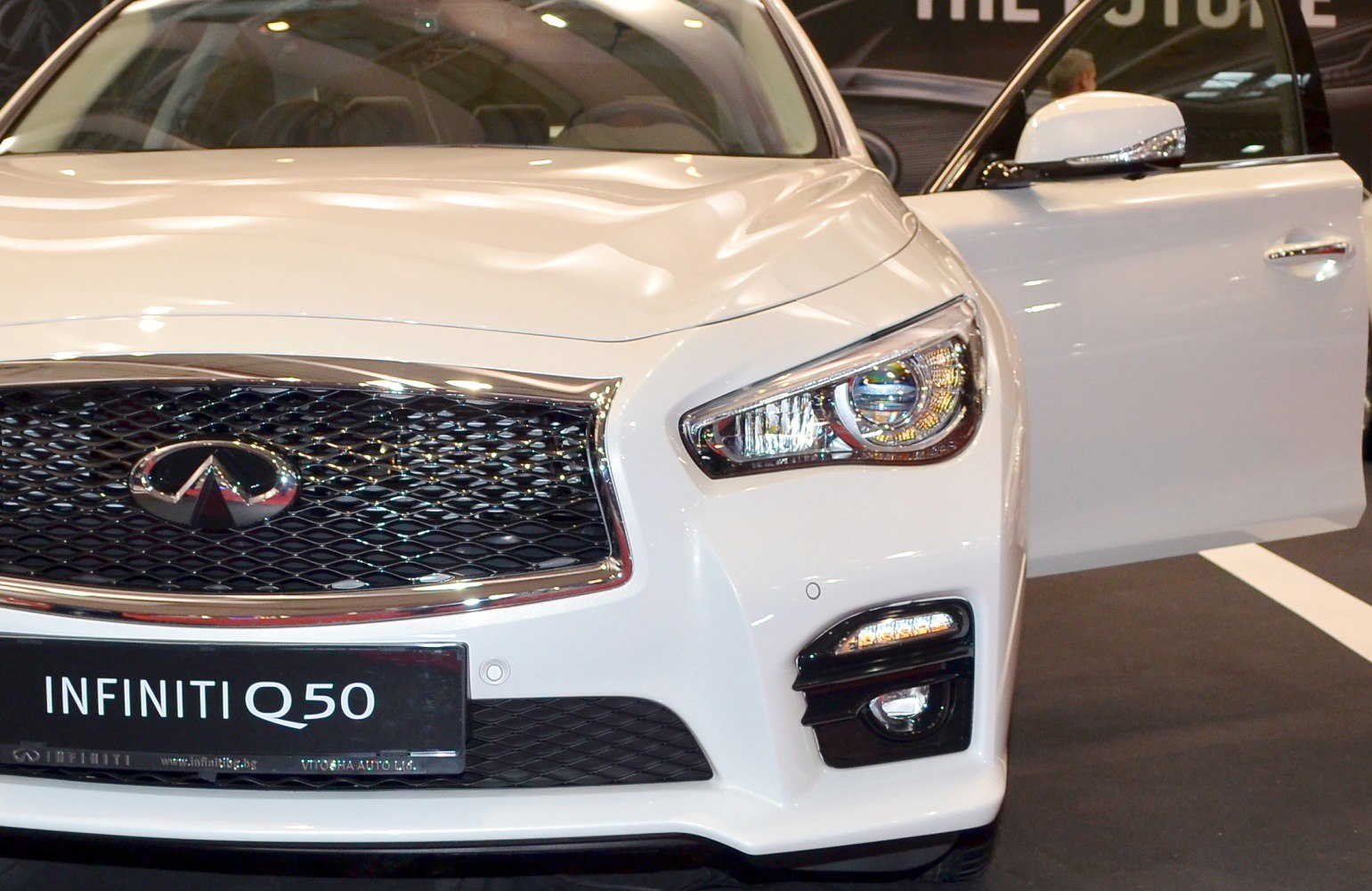 Front grille and headlight close-up with open door