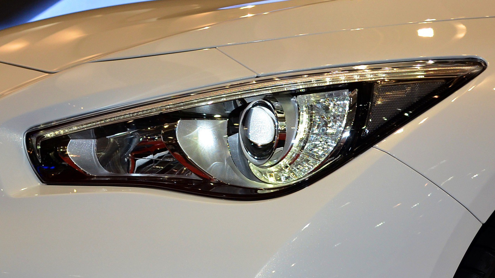 Close-up of a sleek, modern car headlight with projector and LED elements