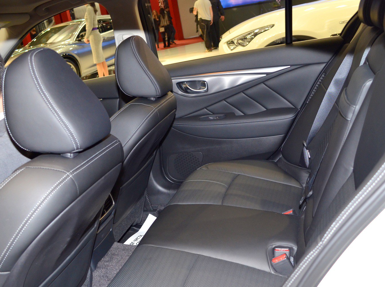 Premium leather rear seats with detailed stitching and a stylish door panel.