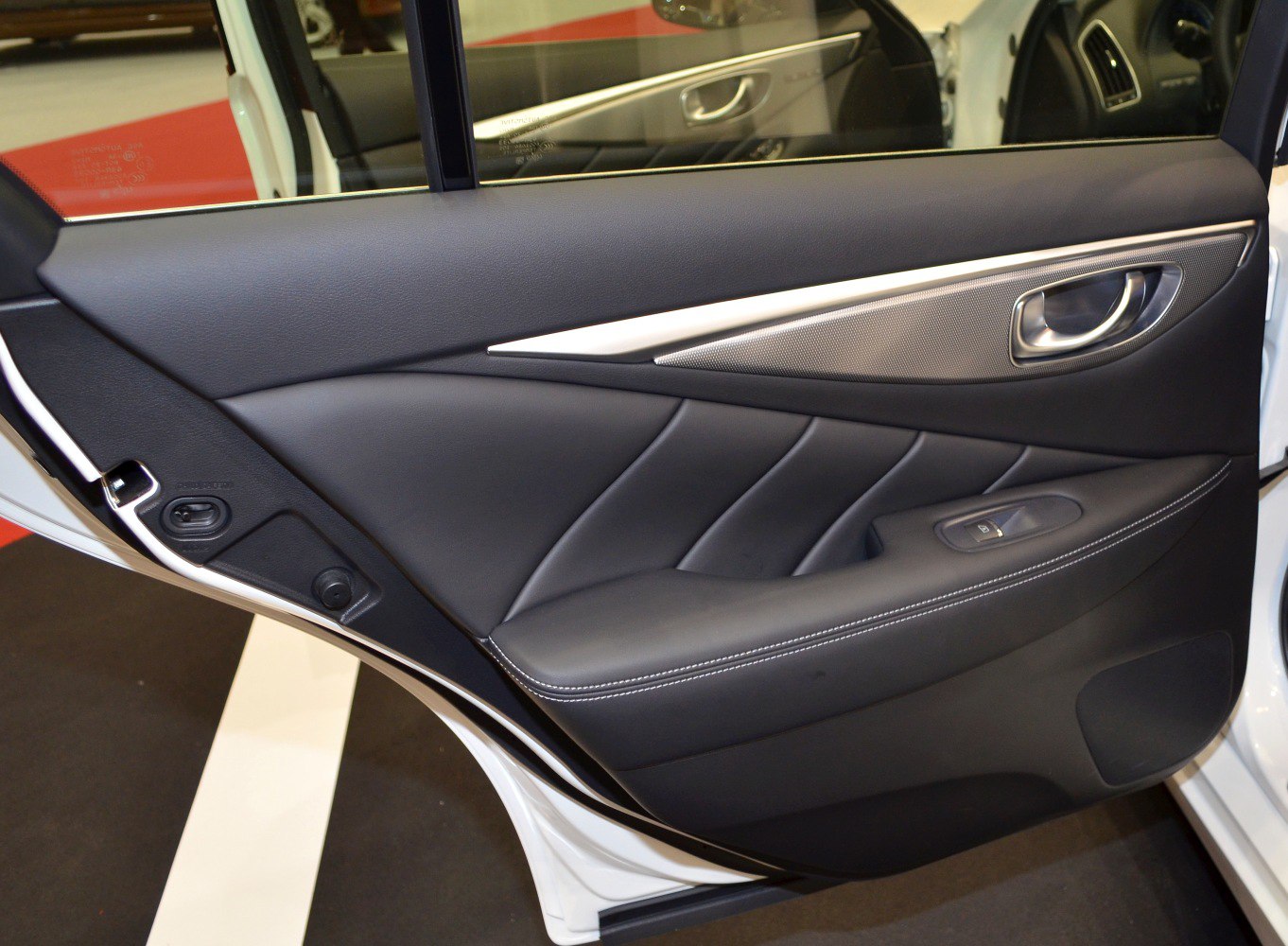 Premium leather interior door panel with sleek handle and window control switch