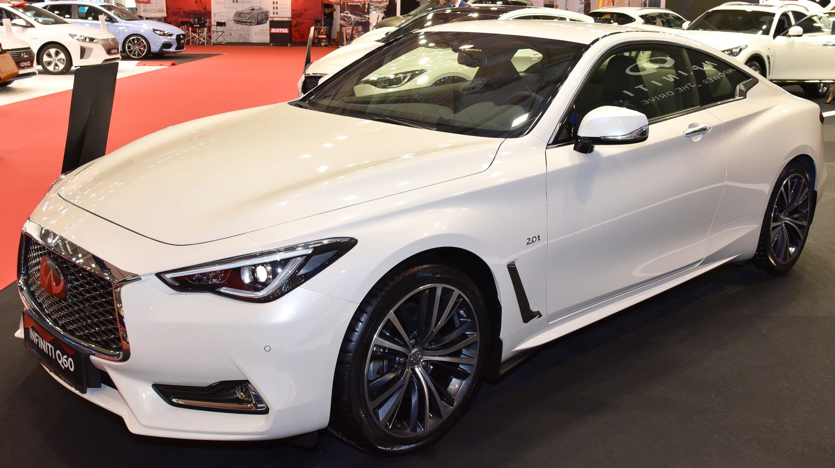 White coupe with sleek design and distinctive front grille