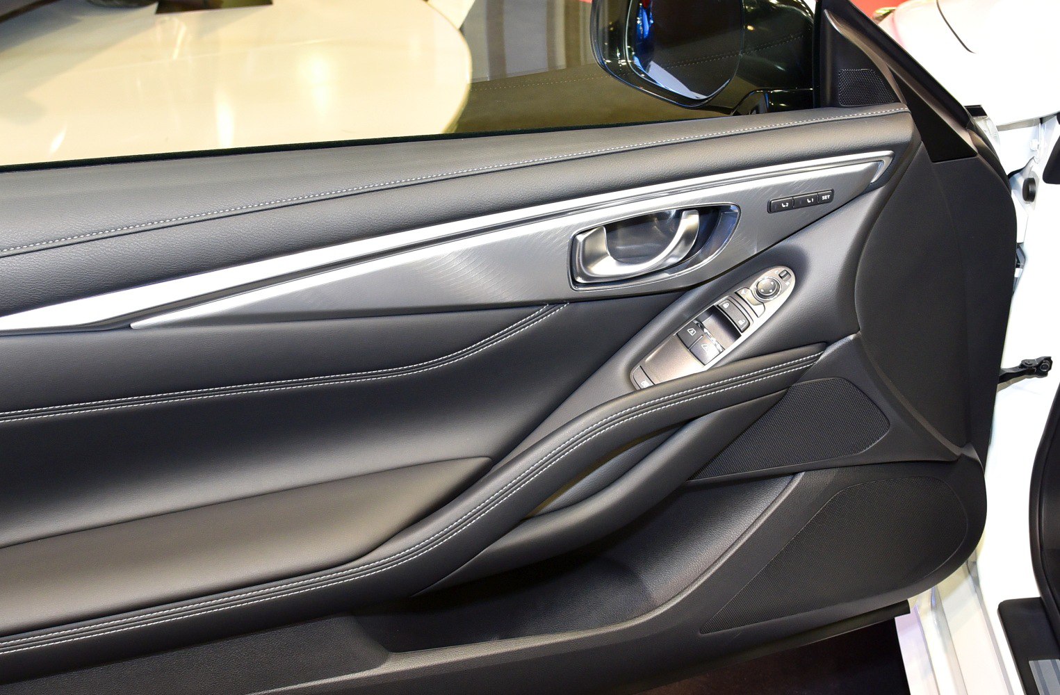 Car door interior panel with window controls and leather finish