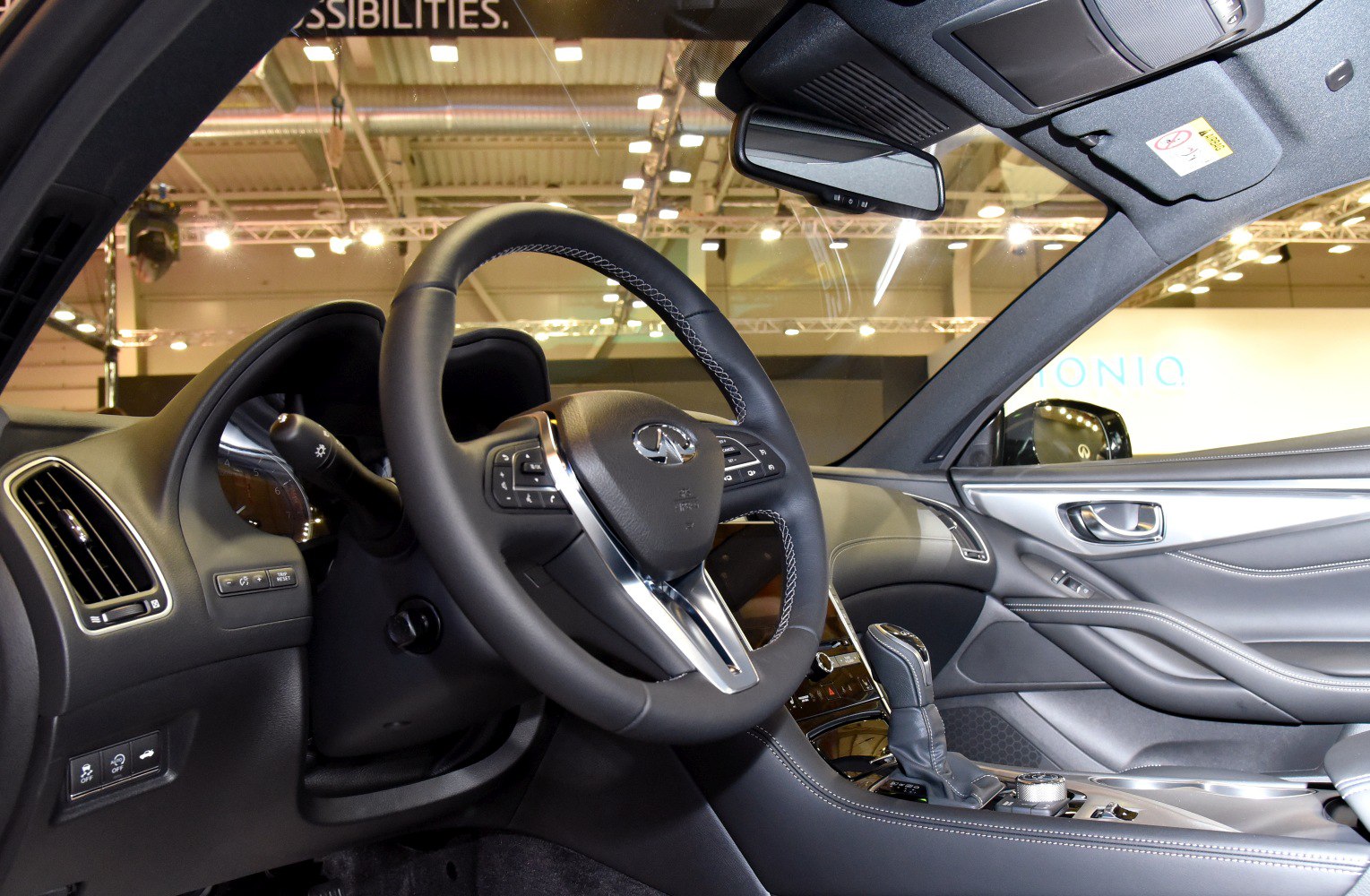 Luxury steering wheel and dashboard with modern controls and leather interior