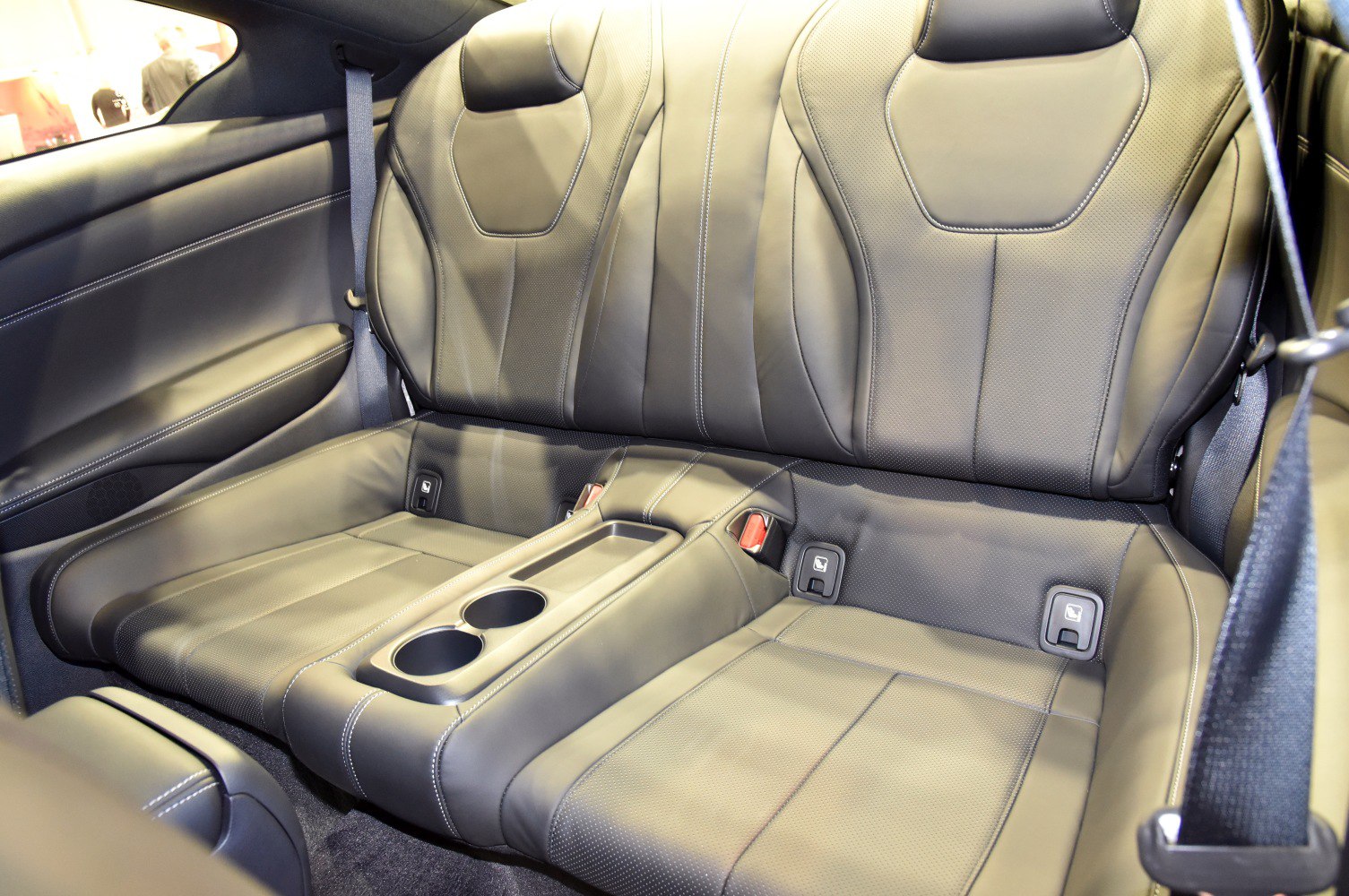 Rear leather seats with cup holders in a modern coupe