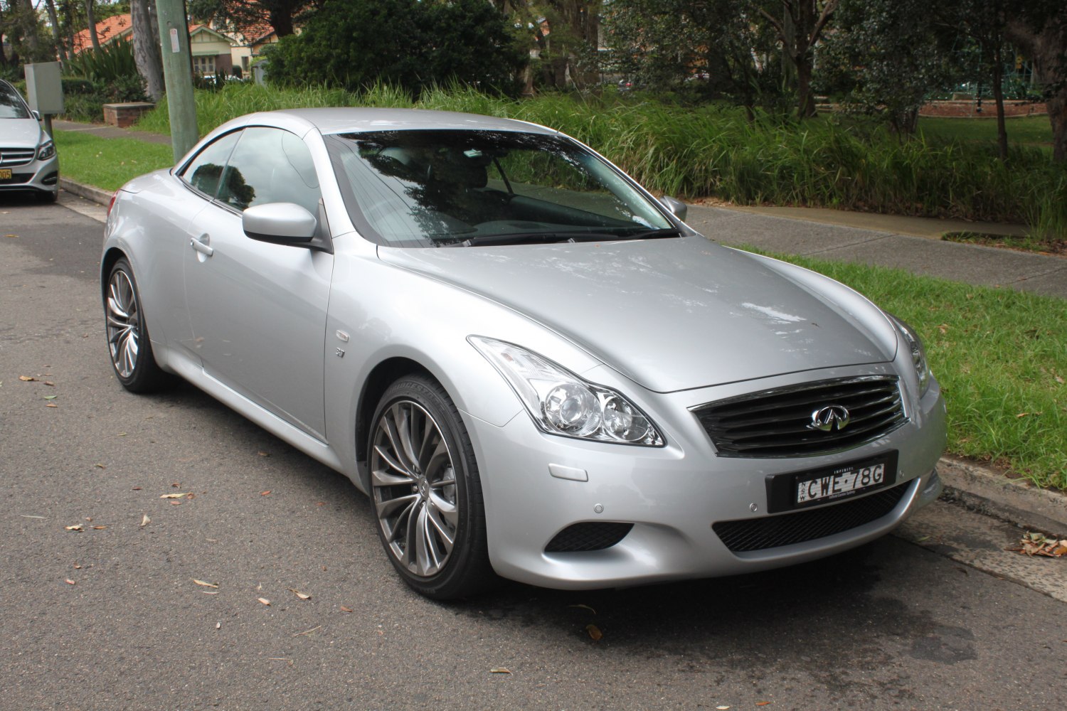 Silver luxury coupe front with grille, headlights, and alloy wheels