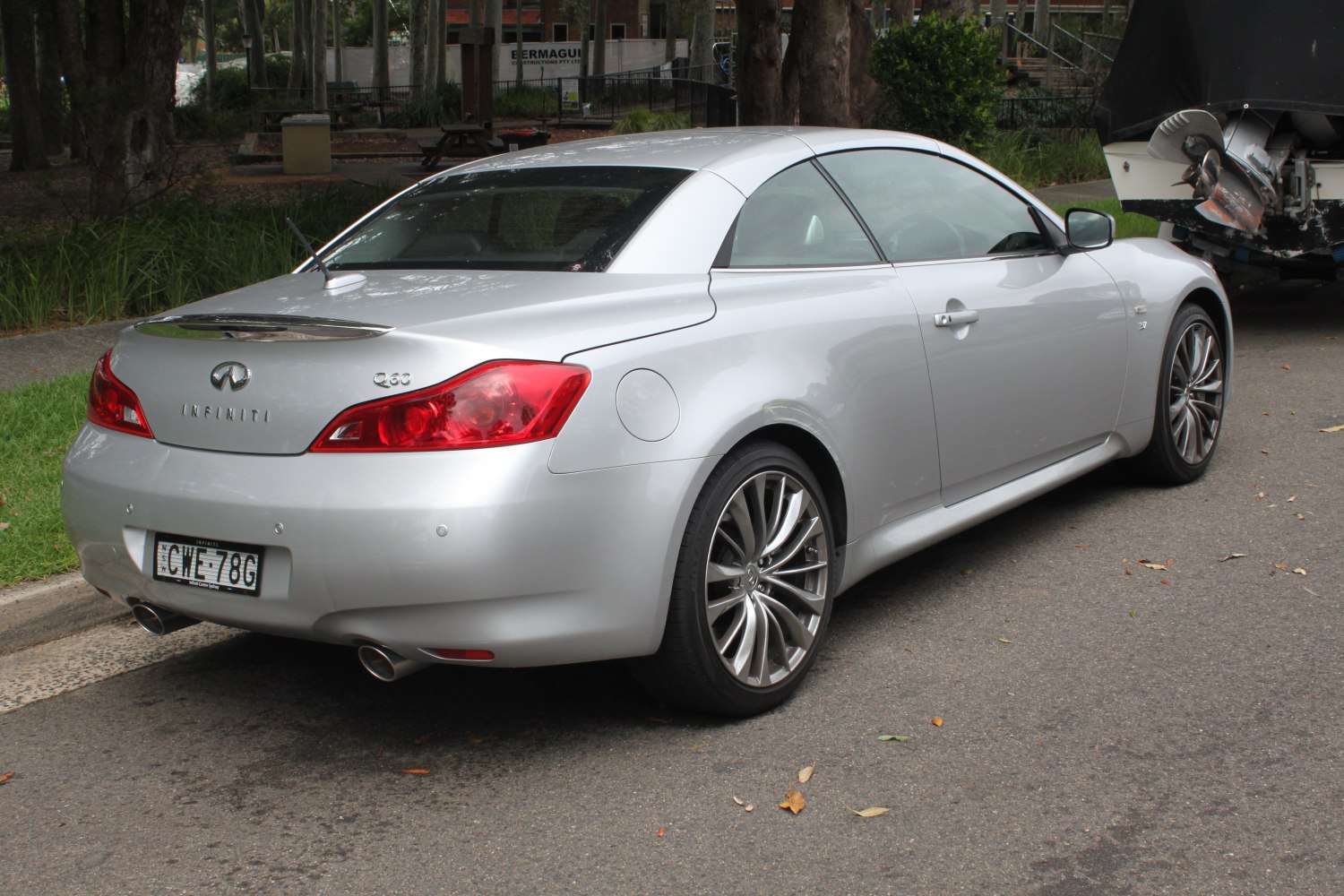 Rear view of silver sporty car with dual exhaust and distinctive taillights
