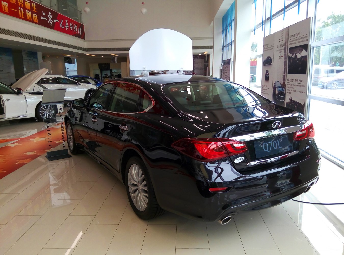 Luxury black sedan rear view with dual exhausts and chrome trim