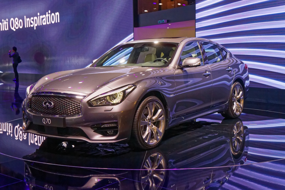 Front and side view of a sleek luxury sedan with modern headlights and alloy wheels