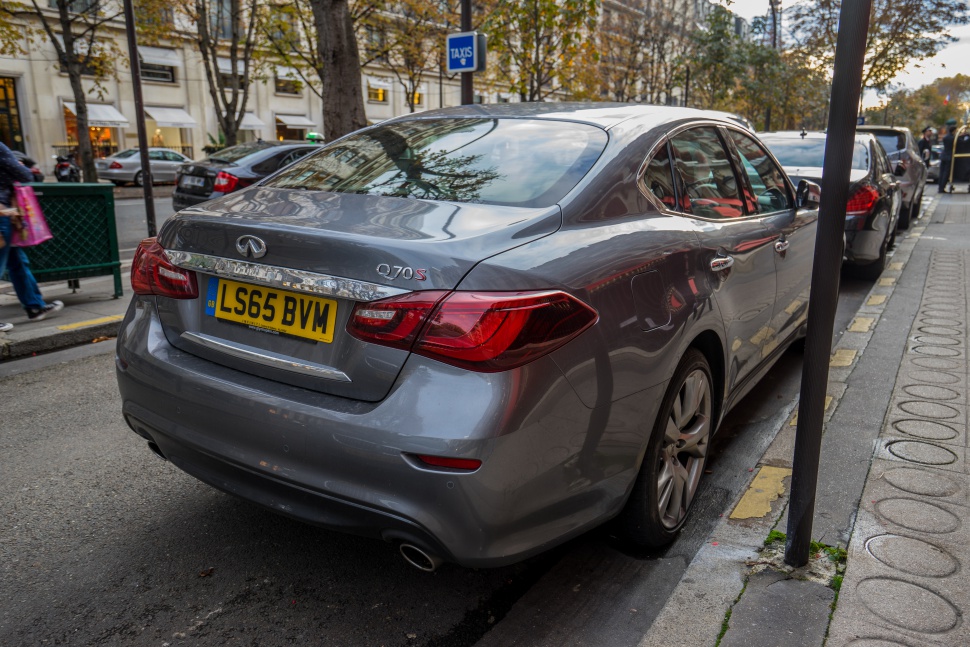 Rear view of a luxury sedan with distinct taillights and dual exhaust pipes.