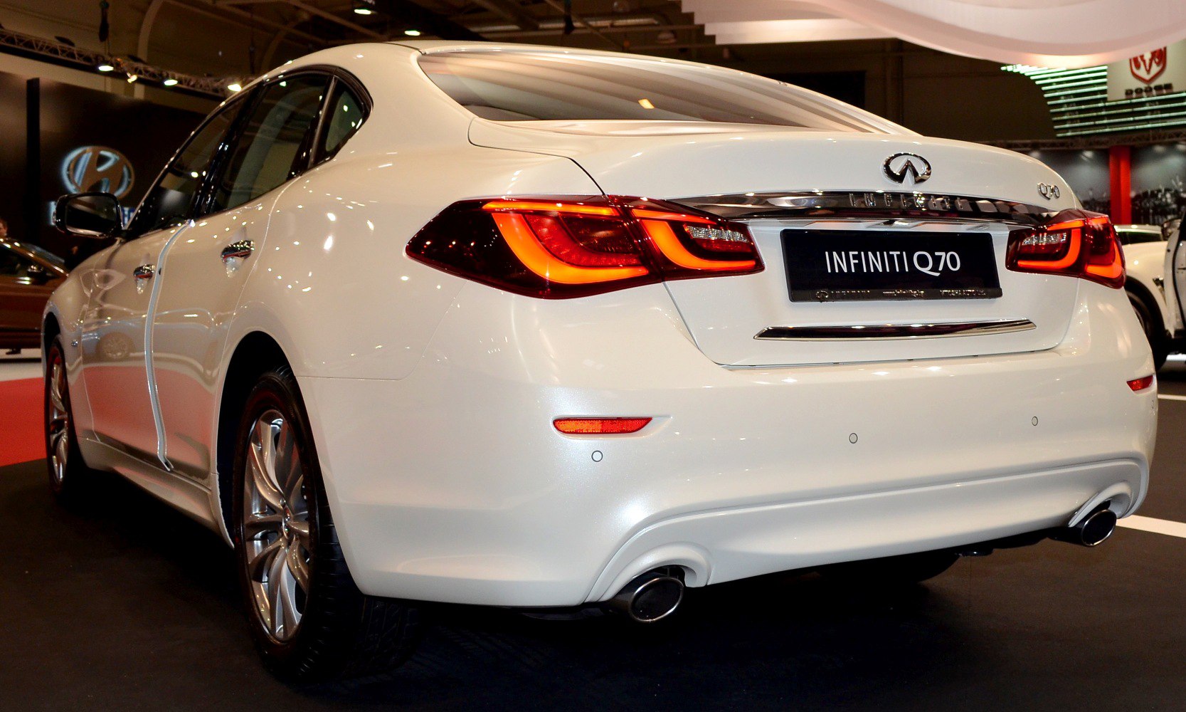 LED taillights and dual exhaust on rear of white luxury sedan