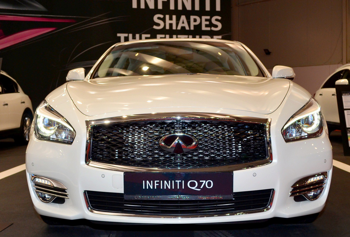 Bold chrome grille and LED headlights in close-up.
