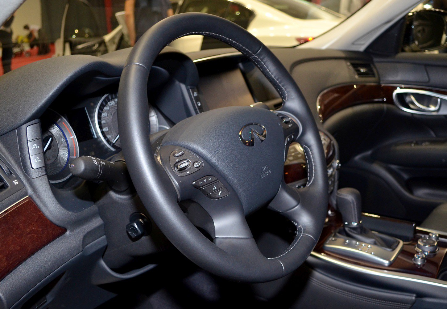 Luxury steering wheel and dashboard with wood trim and control buttons
