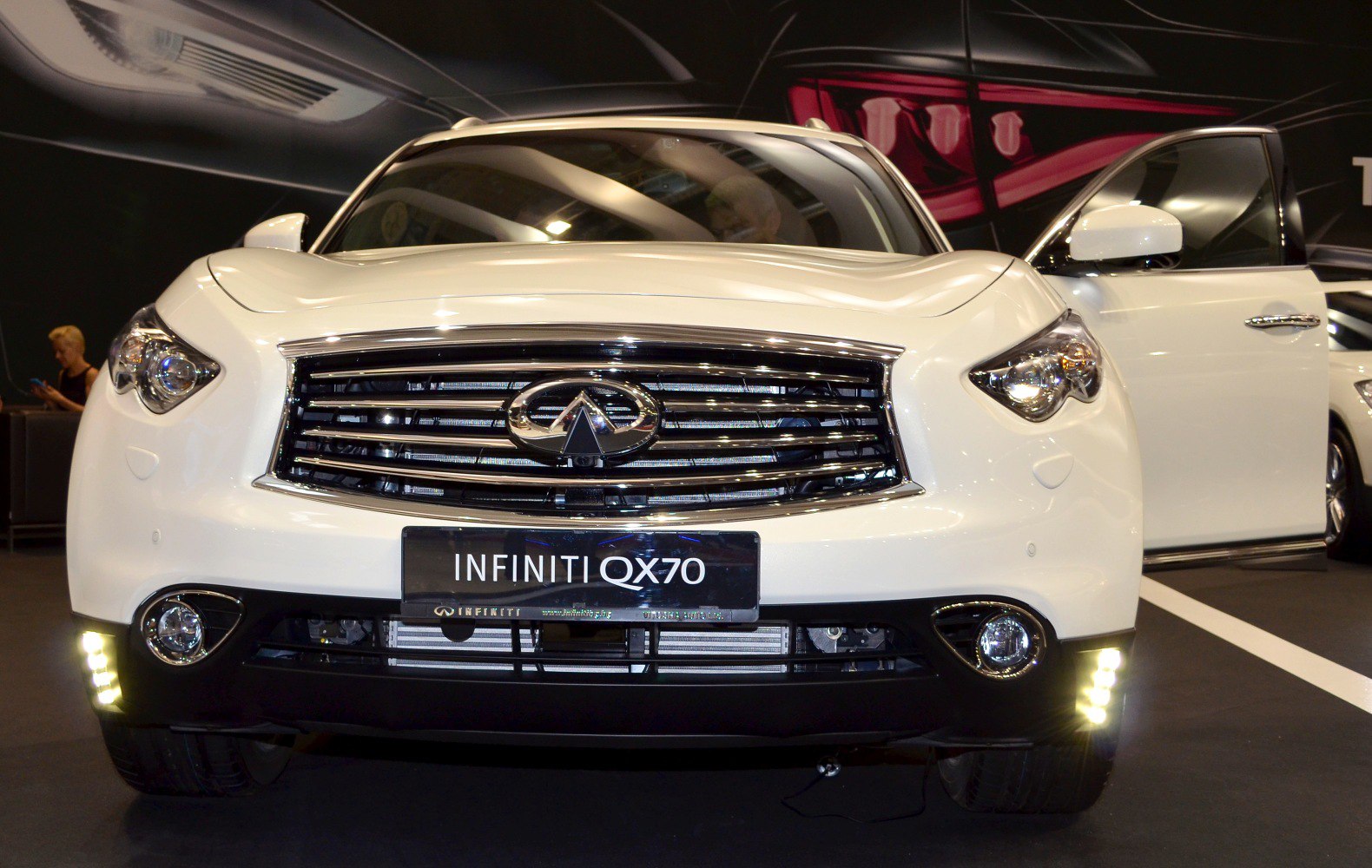 Front grille, headlights, and LED daytime running lights of a white SUV.