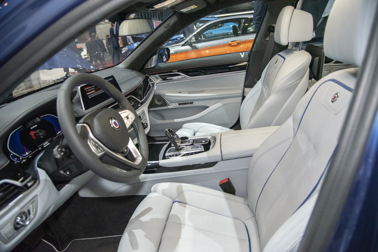 White leather front seats with digital dashboard and center console controls