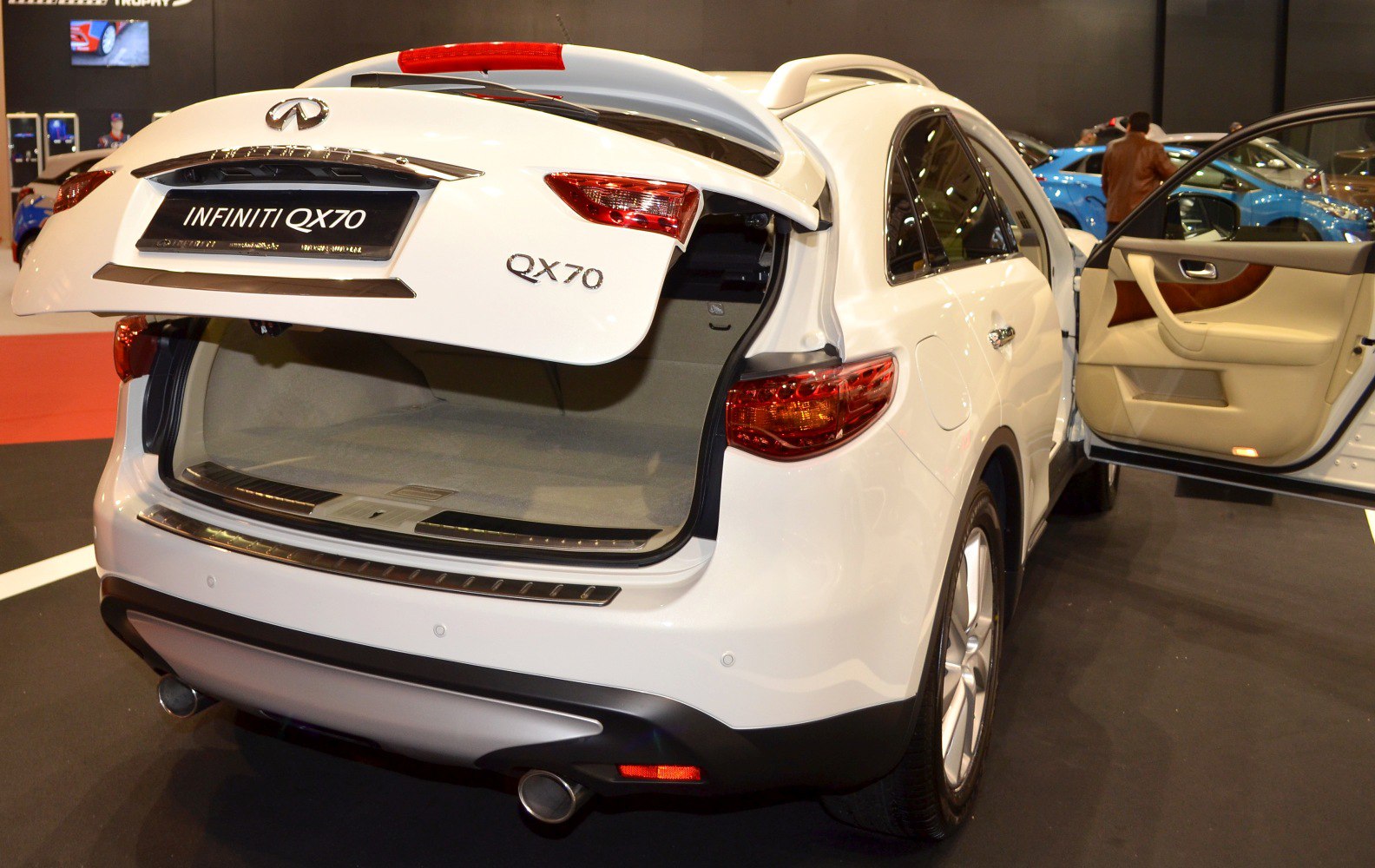 Open rear trunk and side door of white SUV