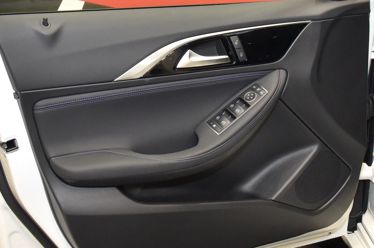 Black interior door panel with controls and silver handle